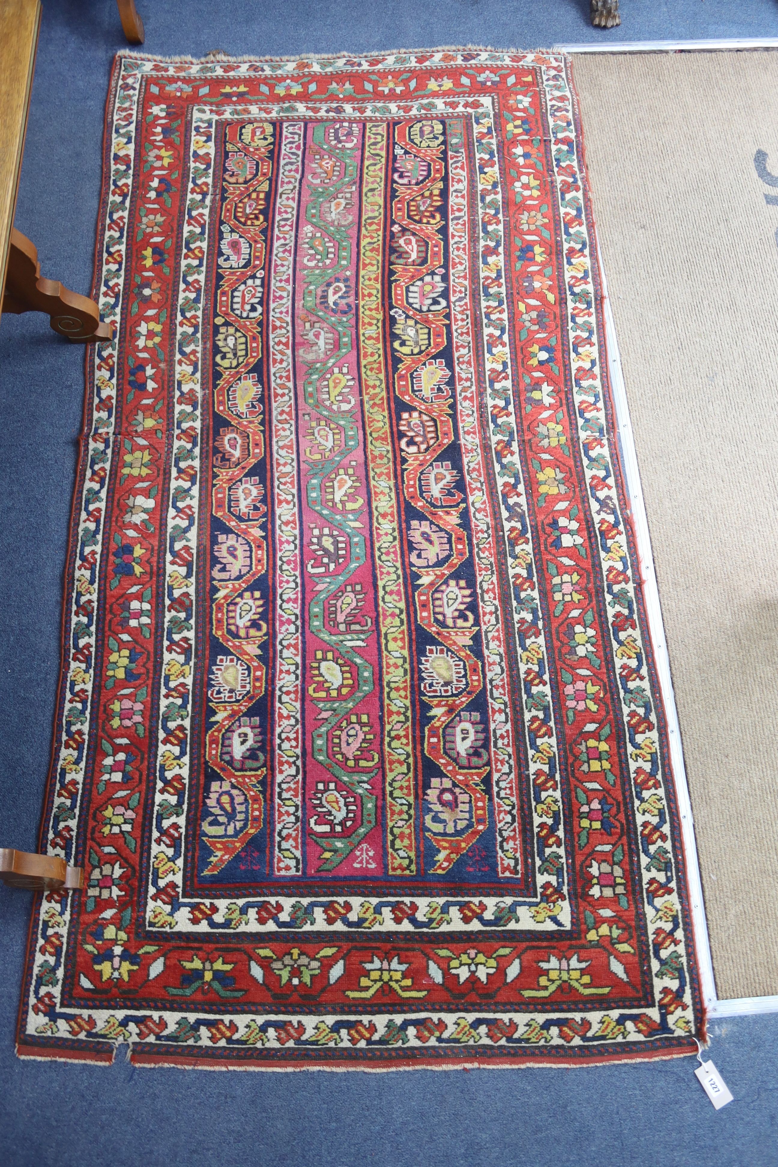 A Caucasian design Boteh red ground rug, 236 x 116cm
